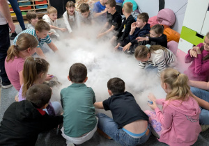 Dzieci wykonują eksperymenty z suchym lodem