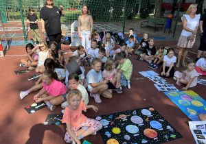 uczniowie prezentują prace na boisku szkolnym