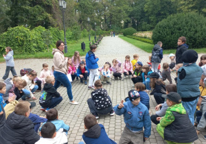 Dzieci kucają w kole w parku