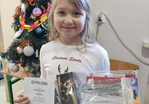 uczennica z dyplomem i nagrodą z konkursu