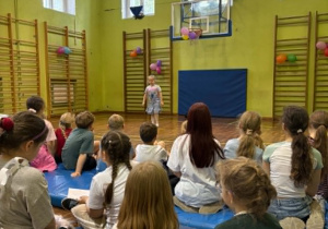 uczniowie tańczą na sali gimnastycznej